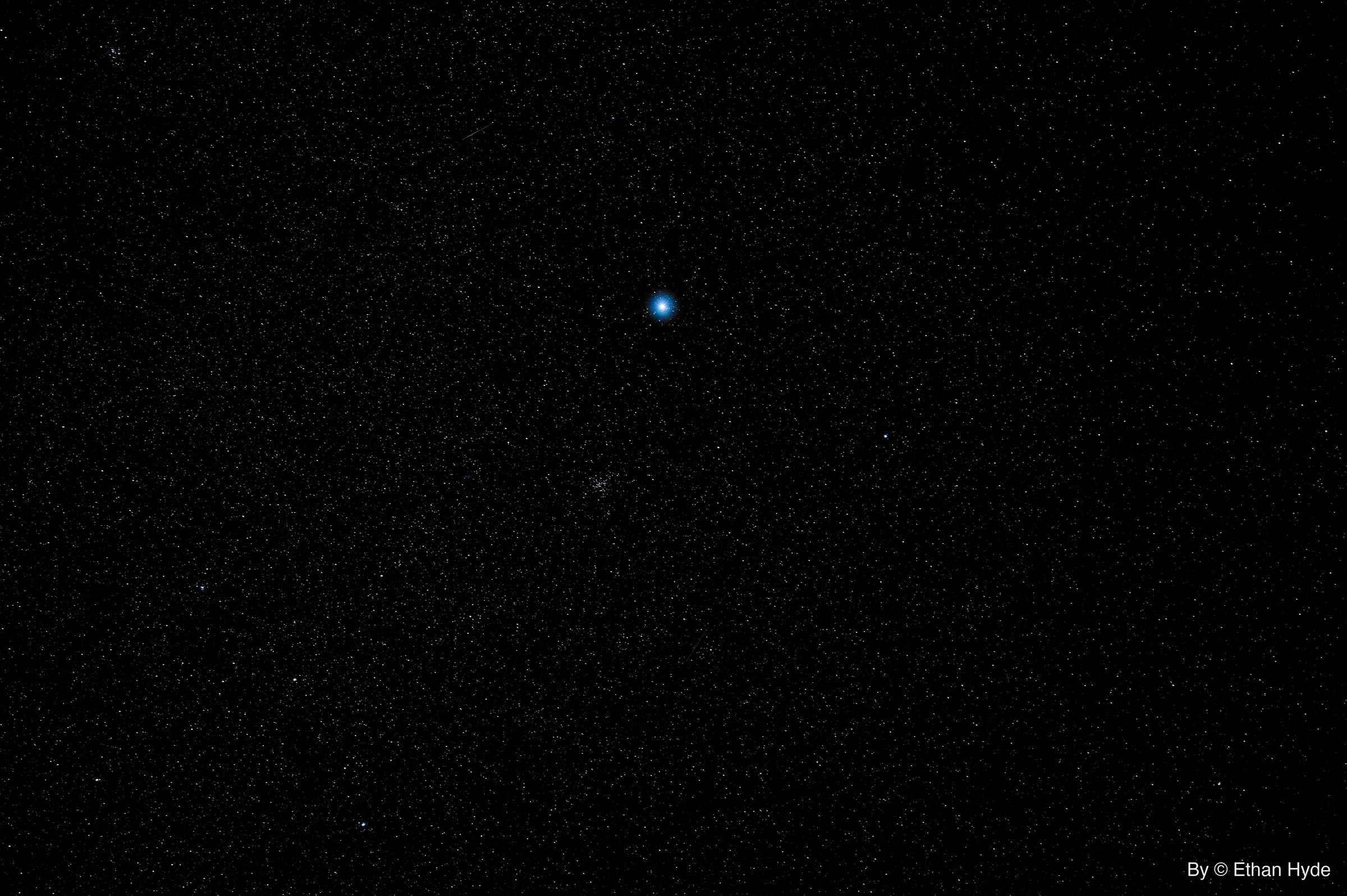 A single bright point of light in a deep, near-empty night sky over Southern Nevada.