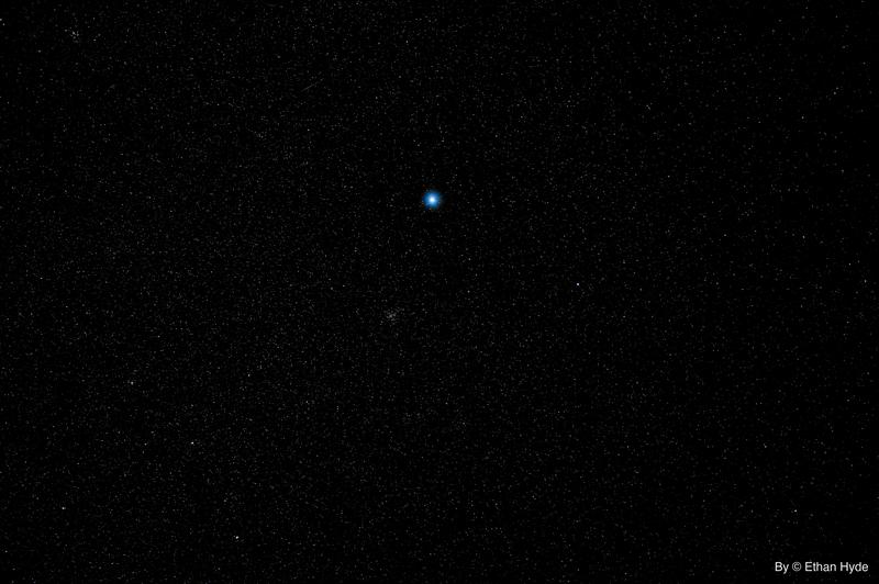 A single bright point of light in a deep, near-empty night sky over Southern Nevada.