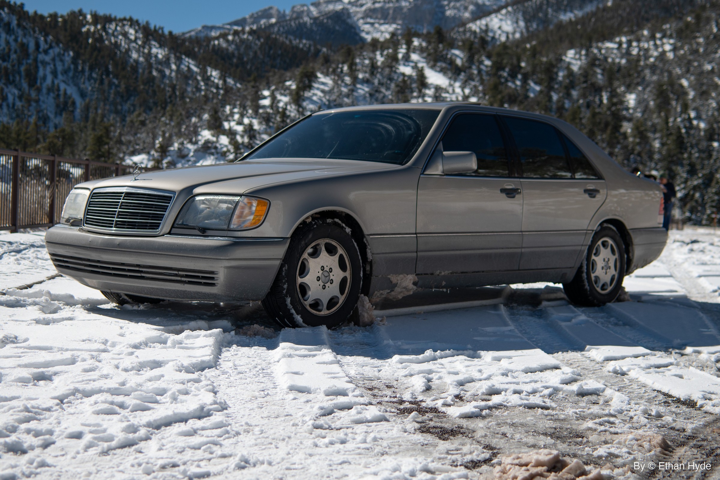 A silver Mercedes-Benz sedan parked in fresh snow.
