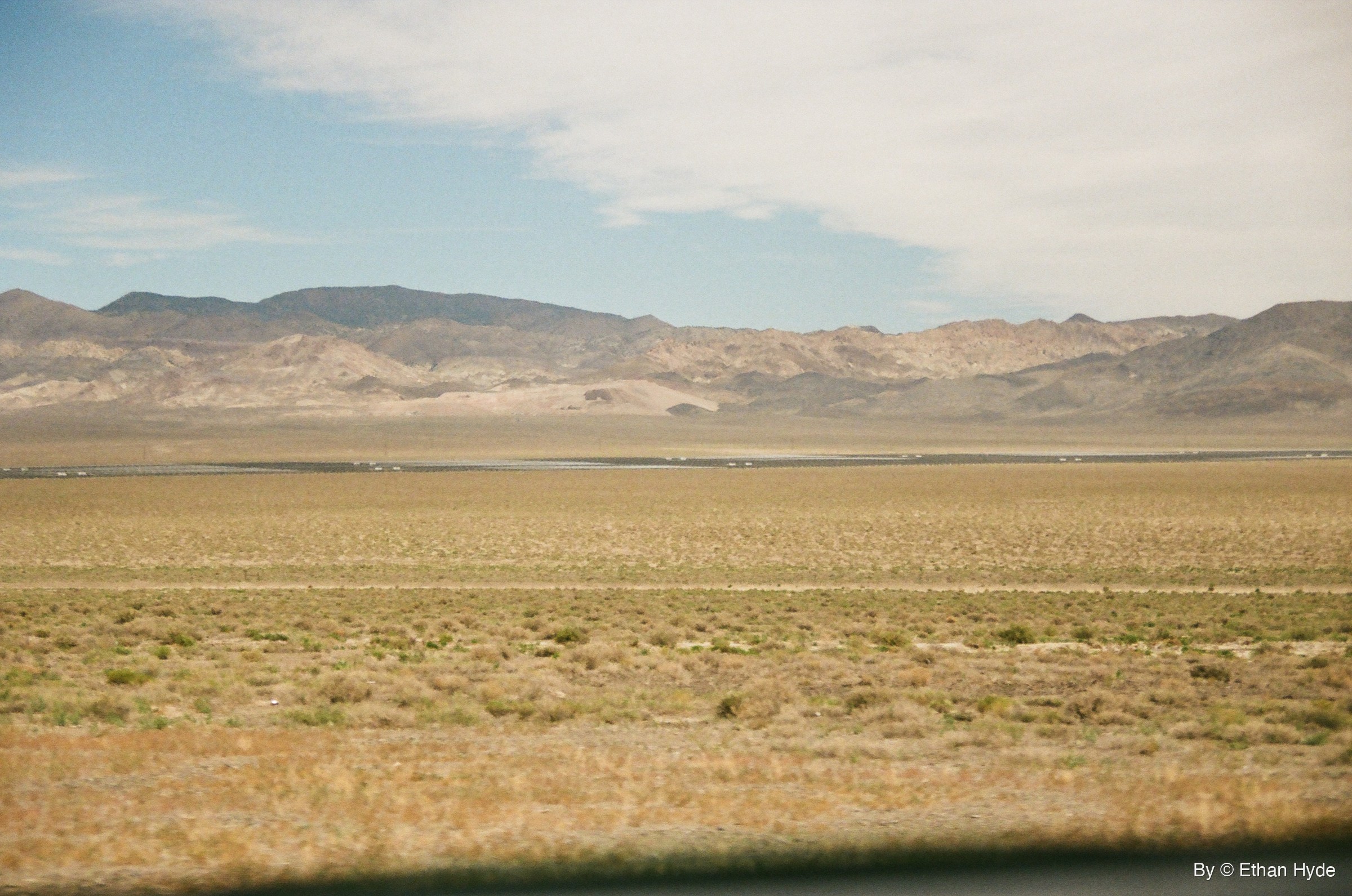 A wide desert basin with a solar plant on the far valley floor near Luning, Nevada, shot on film.