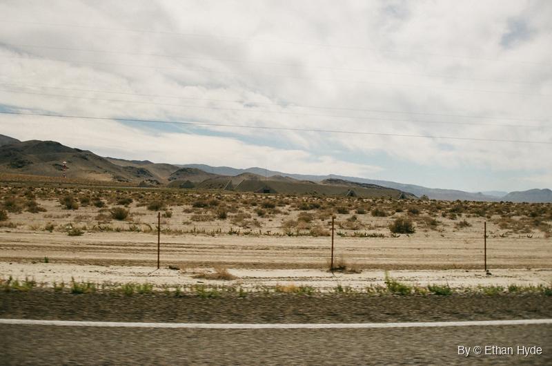 Earth-covered ammunition bunkers spread across a desert valley near Hawthorne, Nevada, shot on film.