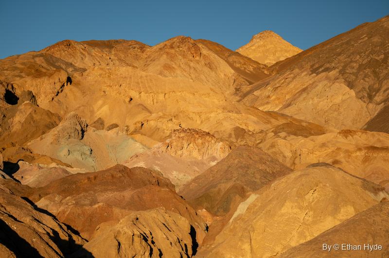 Late golden light on the hills of Artist's Palette, faint green tints showing through the orange rock.