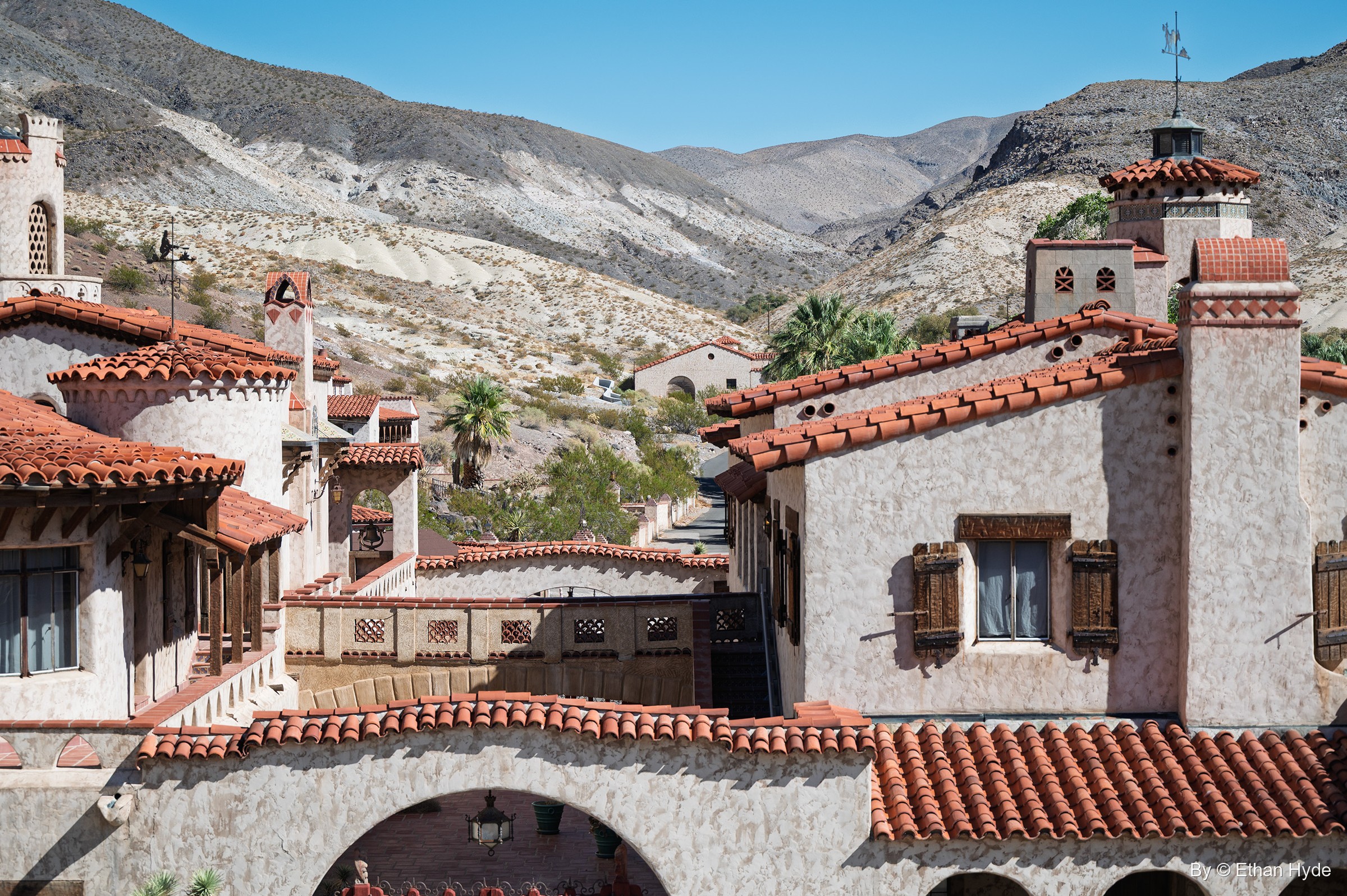 Stucco towers, chimneys and red tile roofs of Scotty's Castle rise from the Grapevine Canyon oasis in northern Death Valley.