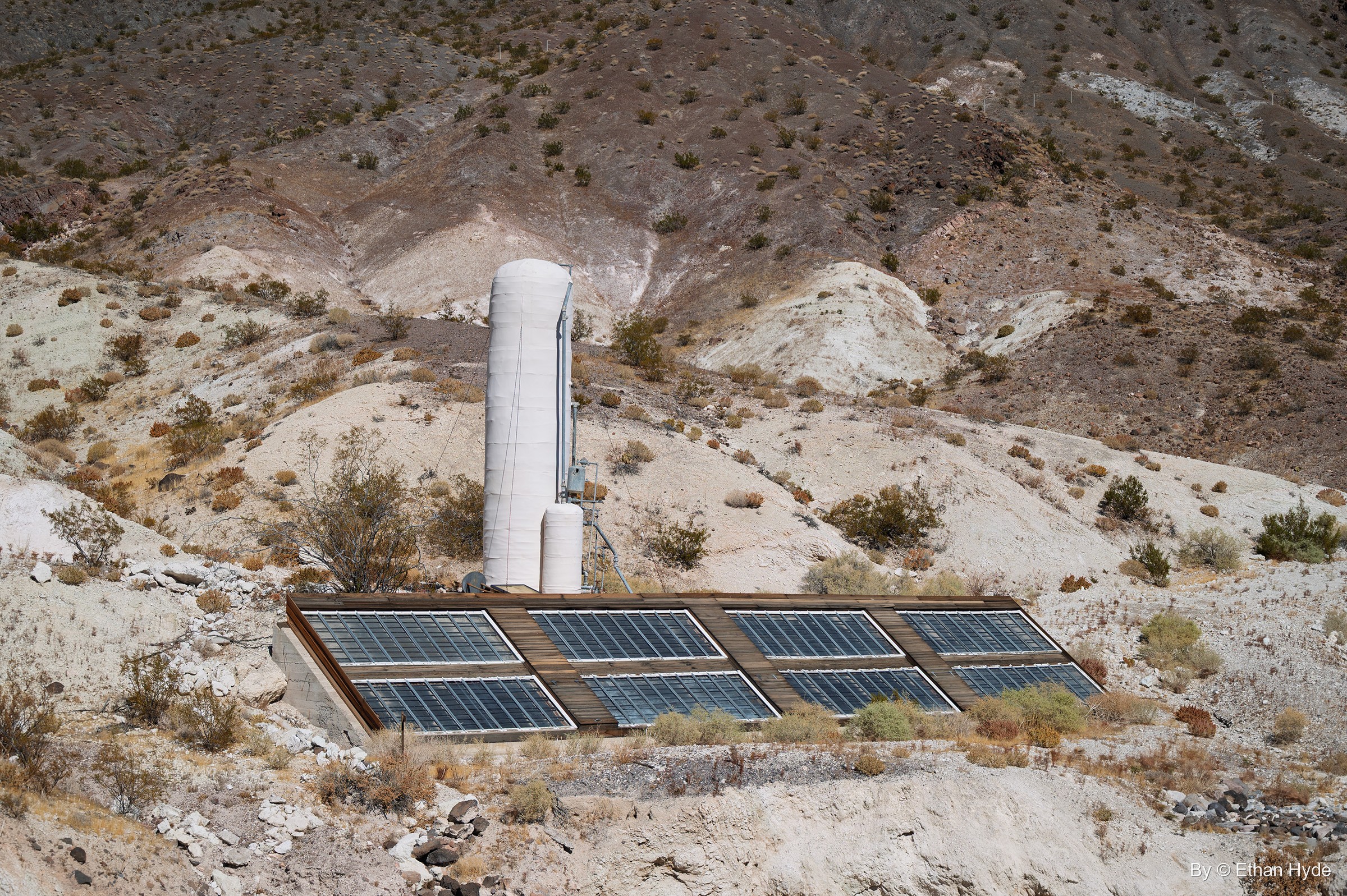 The historic solar water heater on the hill west of Scotty's Castle, installed in 1929, its panels and white tank on a dry slope.
