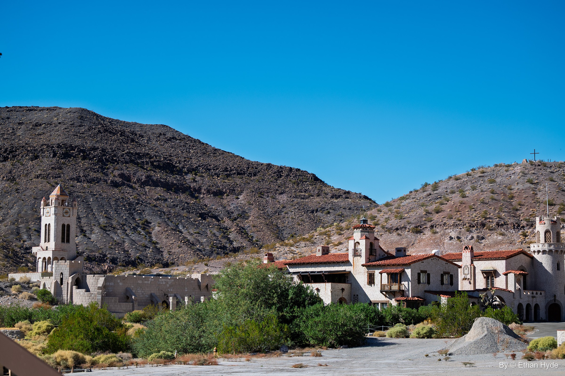 The full length of Scotty's Castle, from the Chimes Tower to the main house and annex, beneath the dark slopes of Grapevine Canyon.