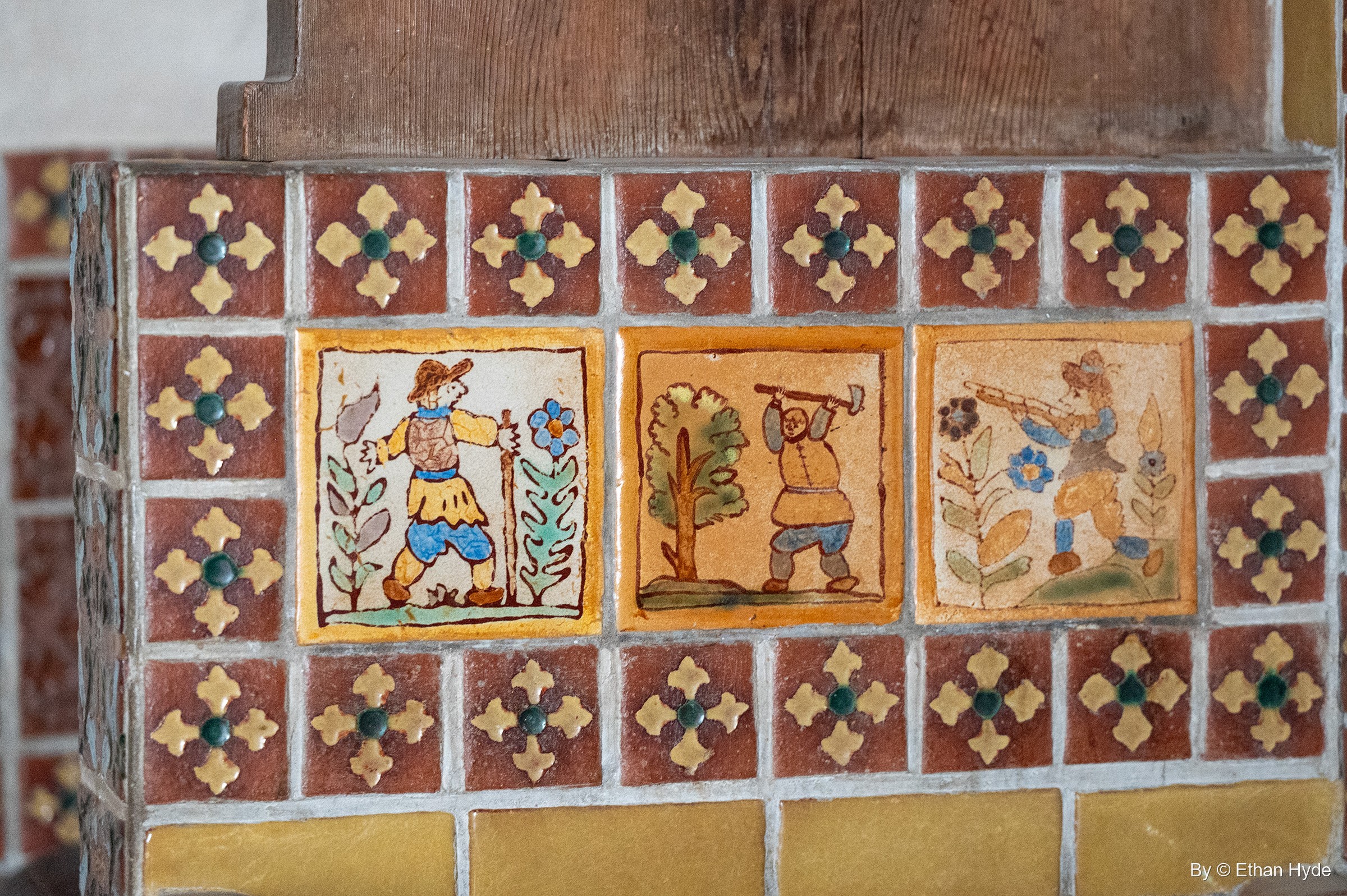 Three hand-painted figure tiles set in a band of red, gold and green patterned tile in the kitchen at Scotty's Castle.