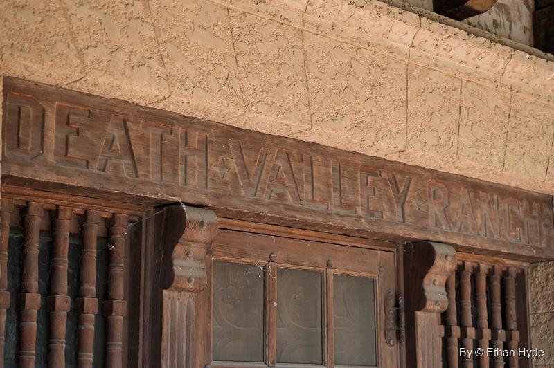 "Death Valley Ranch" carved into the wooden lintel above the main entrance of Scotty's Castle, over turned wooden spindles.