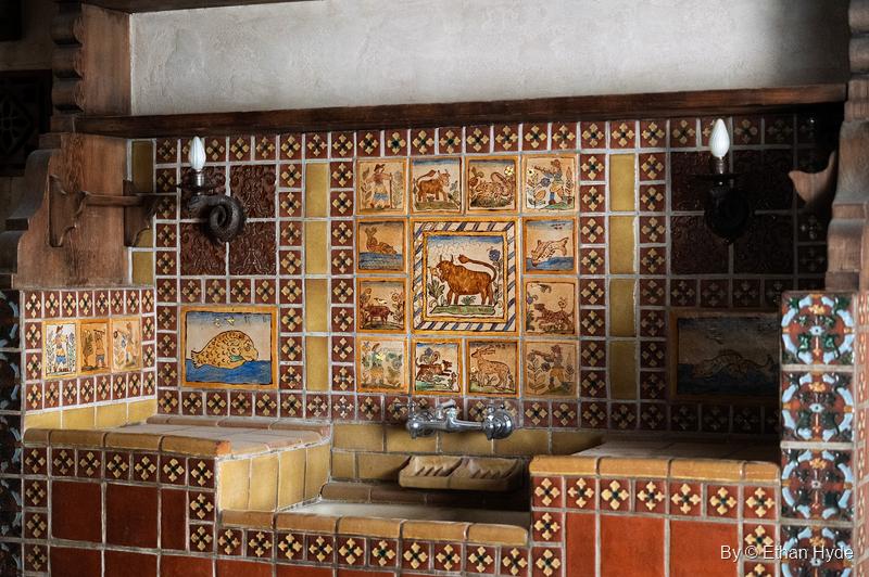 The kitchen sink at Scotty's Castle beneath a wall of hand-painted tile, with the Ferdinand the Bull panel in the middle.