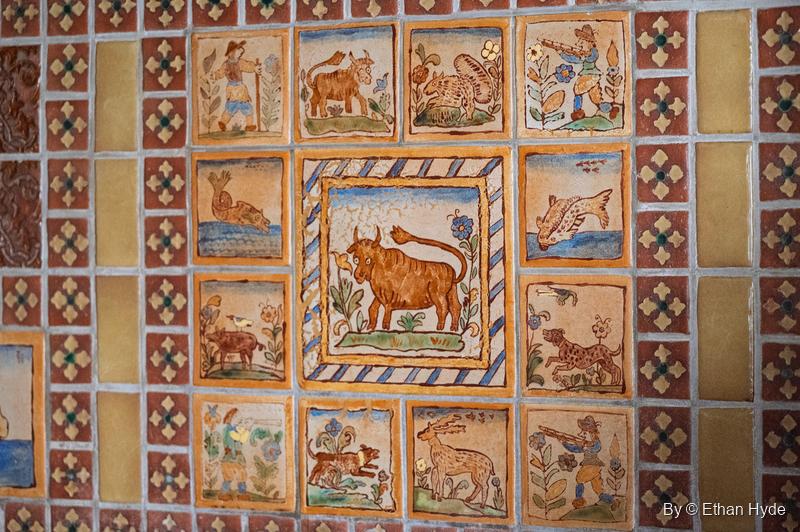 Imported Spanish tiles above the kitchen sink at Scotty's Castle illustrate Ferdinand the Bull, surrounded by hand-painted animal and figure tiles.