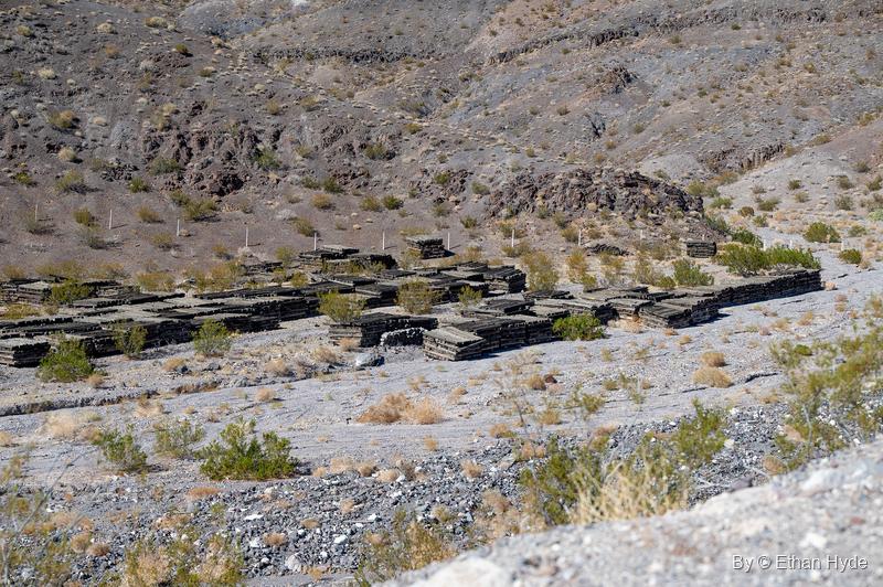 Long rows of stacked railroad ties laid out across Tie Canyon on the hillside near Scotty's Castle.