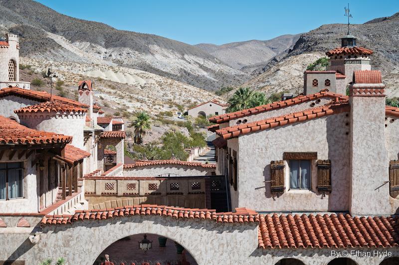 Stucco towers, chimneys and red tile roofs of Scotty's Castle rise from the Grapevine Canyon oasis in northern Death Valley.
