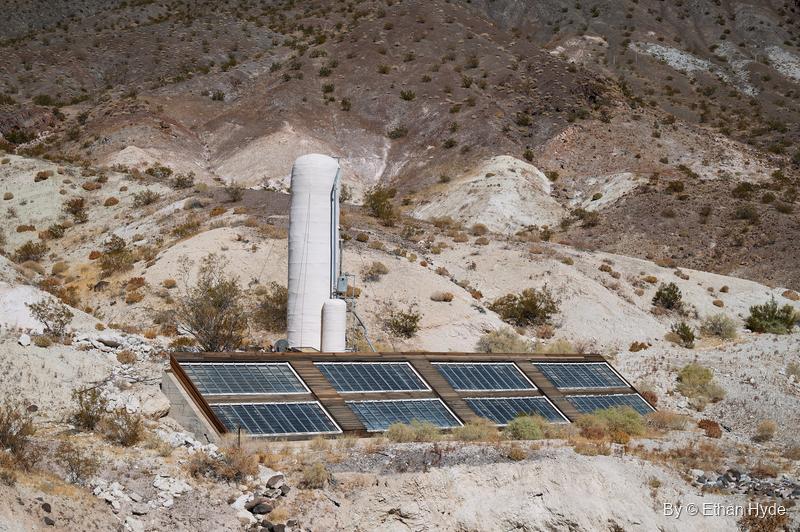 The historic solar water heater on the hill west of Scotty's Castle, installed in 1929, its panels and white tank on a dry slope.